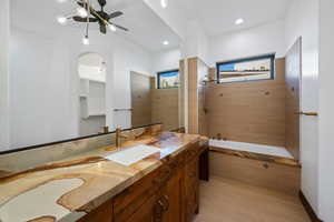 Bathroom featuring tiled shower / bath, vanity, ceiling fan, and recessed lighting