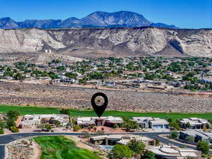 Aerial perspective of suburban area with mountains and a local golf course