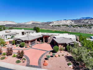 View of front of home with a mountain view, stone siding, concrete driveway, and an attached garage