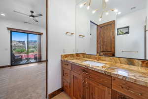 Bathroom featuring vanity, recessed lighting, a ceiling fan, light carpet, and a mountain view