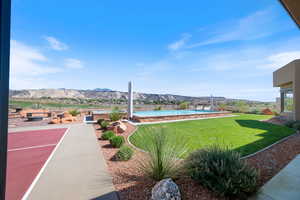 View of yard with a mountain view, a patio area, an outdoor pool, and an outdoor fire pit