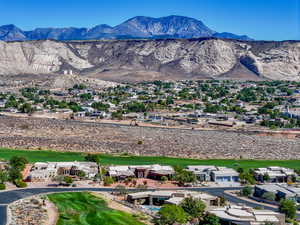 Aerial perspective of suburban area with mountains and a local golf course