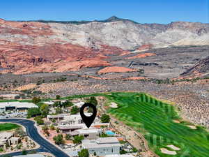 Aerial overview of property's location with mountains and a golf course