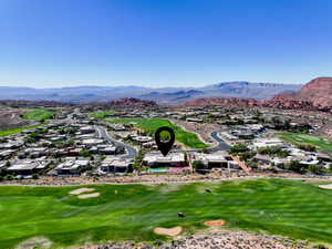 Aerial view of residential area with a golf club and a mountain backdrop