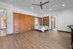 Bedroom with ceiling fan, light wood-style flooring, and recessed lighting