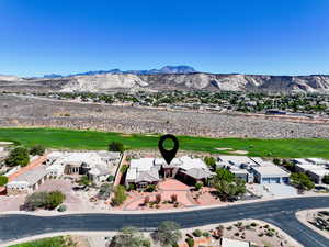 Drone / aerial view of a mountain backdrop and a golf club