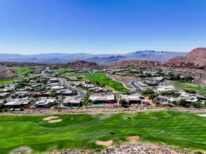 Aerial view of residential area with a local golf course and a mountain backdrop