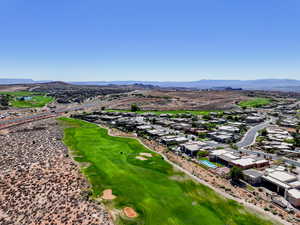 Aerial view of residential area featuring a local golf course and a mountainous background