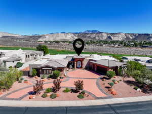 View of front of house with a mountain view and driveway