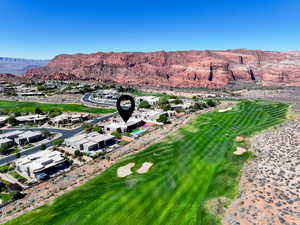 View of property location with a golf club, a mountain backdrop, and nearby suburban area