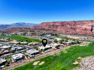 Aerial view of residential area featuring a golf course and a mountain backdrop