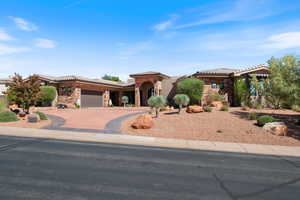 Mediterranean / spanish-style house featuring stone siding, concrete driveway, an attached garage, a tiled roof, and stucco siding