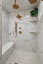 Bathroom featuring a tile shower