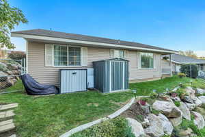 Back of house featuring a shingled roof