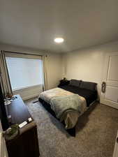 Bedroom featuring carpet and baseboards