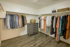 Master Closet featuring dark wood finished floors and attic access
