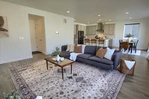 Living room featuring wood finished floors and recessed lighting