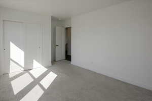 Unfurnished bedroom with carpet flooring and a closet