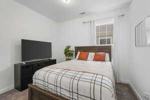 Carpeted bedroom featuring baseboards