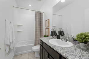 Full bath featuring shower / bath combination with curtain, vanity, light tile patterned floors, and recessed lighting