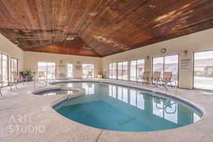 View of swimming pool featuring a pool with connected hot tub
