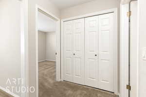 Corridor with carpet flooring and a textured ceiling