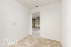 Spare room featuring stone finish flooring and baseboards