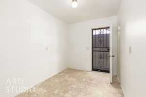 Foyer featuring baseboards and stone finish floors