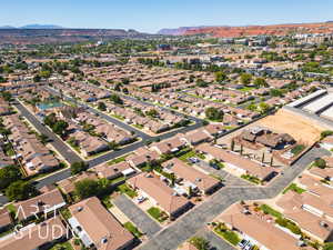 Aerial view of property's location with nearby suburban area and a mountain backdrop