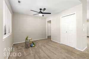 Unfurnished bedroom with carpet flooring, ceiling fan, a textured ceiling, and a closet