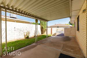 View of patio featuring a gate