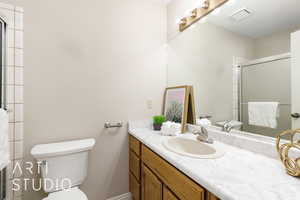 Full bathroom with vanity and a stall shower