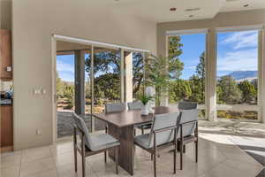 Sunroom / solarium featuring tile patterned flooring and a mountain view