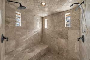 Bathroom with tiled shower and healthy amount of natural light