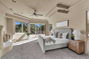 Bedroom with carpet floors, a ceiling fan, and access to exterior