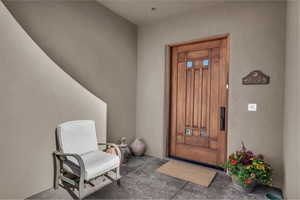 Entrance to property with stucco siding