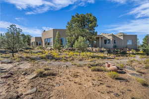 Back of house featuring stucco siding