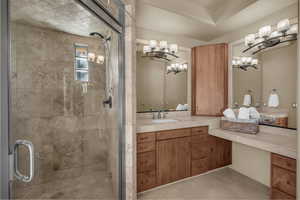 Full bathroom with a shower stall, vanity, and light tile patterned flooring