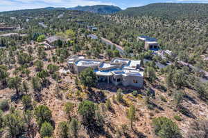 Aerial view of property and surrounding area with a mountainous background