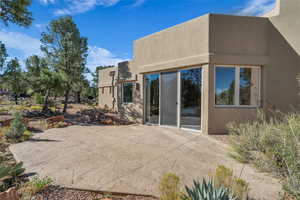 Rear view of house featuring a patio and stucco siding