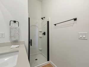 Bathroom featuring a stall shower and light wood-type flooring