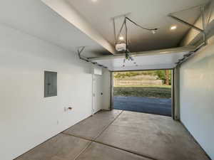 Garage with electric panel and a garage door opener