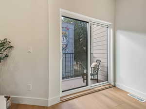 Doorway featuring wood finished floors