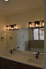 Full bath featuring a garden tub and double vanity