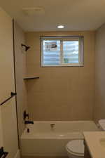 Bathroom with vanity, bathing tub / shower combination, and recessed lighting