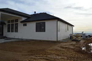 View of property exterior featuring roof with shingles