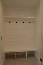 Mudroom featuring baseboards and light tile patterned floors