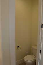 Bathroom with toilet and tile patterned floors