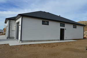 View of home's exterior with a shingled roof