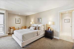 Primary bedroom featuring recessed lighting and carpet flooring